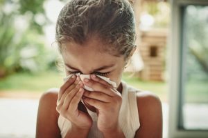 Child sneezing in home without proper filtration and purification 