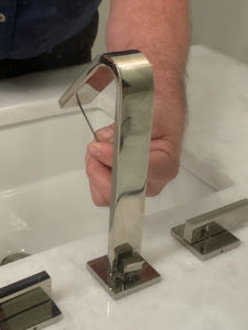 Cooper Mechanical repair technician inspecting bathroom faucet