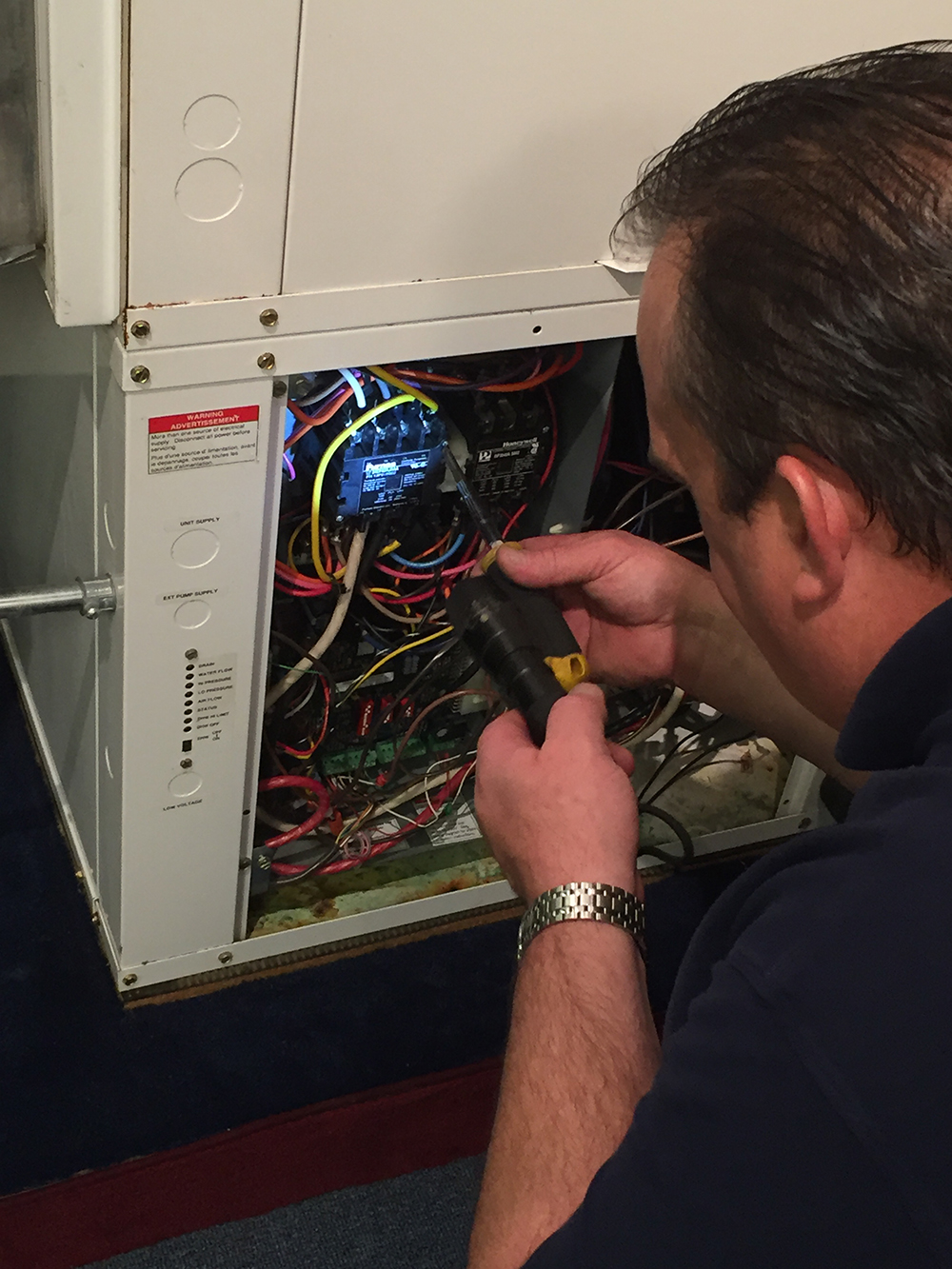 Heating Service Technician Diagnosing Problem