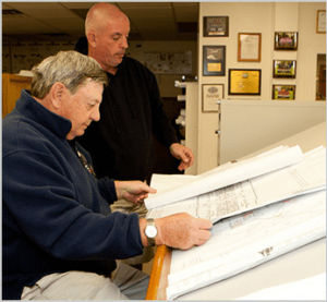 Cooper Mechanical team reviewing blueprints